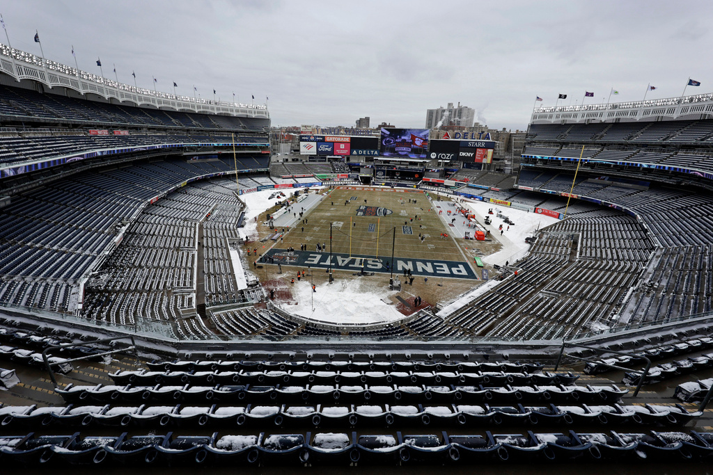 FILE - Snow covers seats before the Pinstripe Bowl NCAA college football game between Clemson and Penn State at Yankee Stadium in New York on Dec. 27, 2025. (AP Photo/Adam Hunger, File)