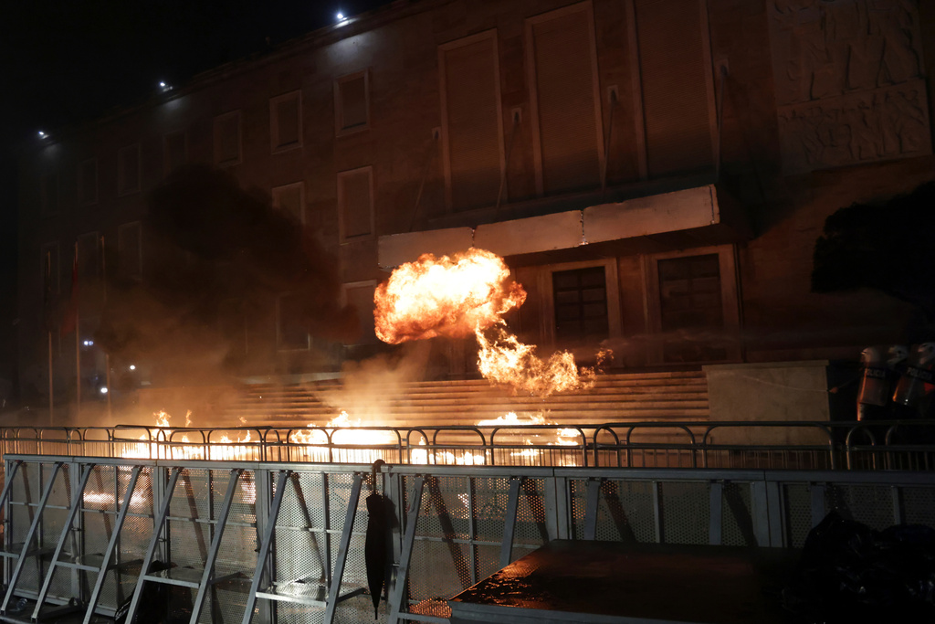 Protesters throw Molotov cocktails during an anti-government rally outside Prime Minister's office over corruption scandals and broader political issues, in Tirana, Albania, Tuesday, Feb. 10, 2026. (AP Photo/Hameraldi Agolli)