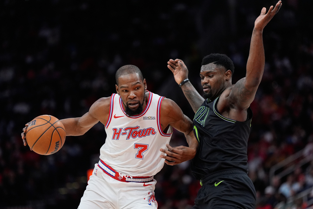 Houston Rockets forward Kevin Durant (7) controls the ball against New Orleans Pelicans forward Zion Williamson (1) during the second half of an NBA basketball game in Houston, Sunday, Jan. 18, 2026. (AP Photo/Ashley Landis)