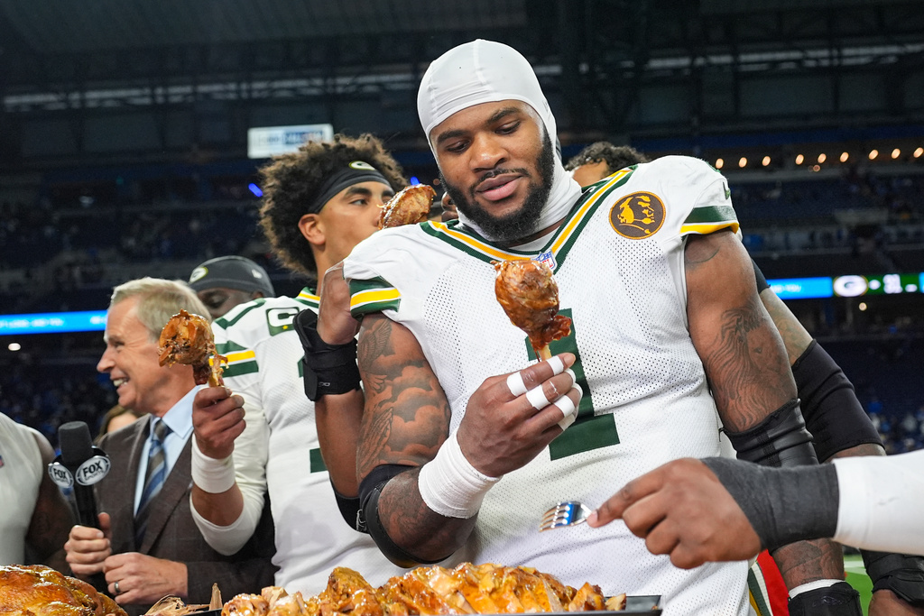 Green Bay Packers defensive lineman Micah Parsons (1) grabs a turkey leg following an NFL football game against the Detroit Lions in Detroit, Thursday, Nov. 27, 2025. (AP Photo/Ryan Sun)