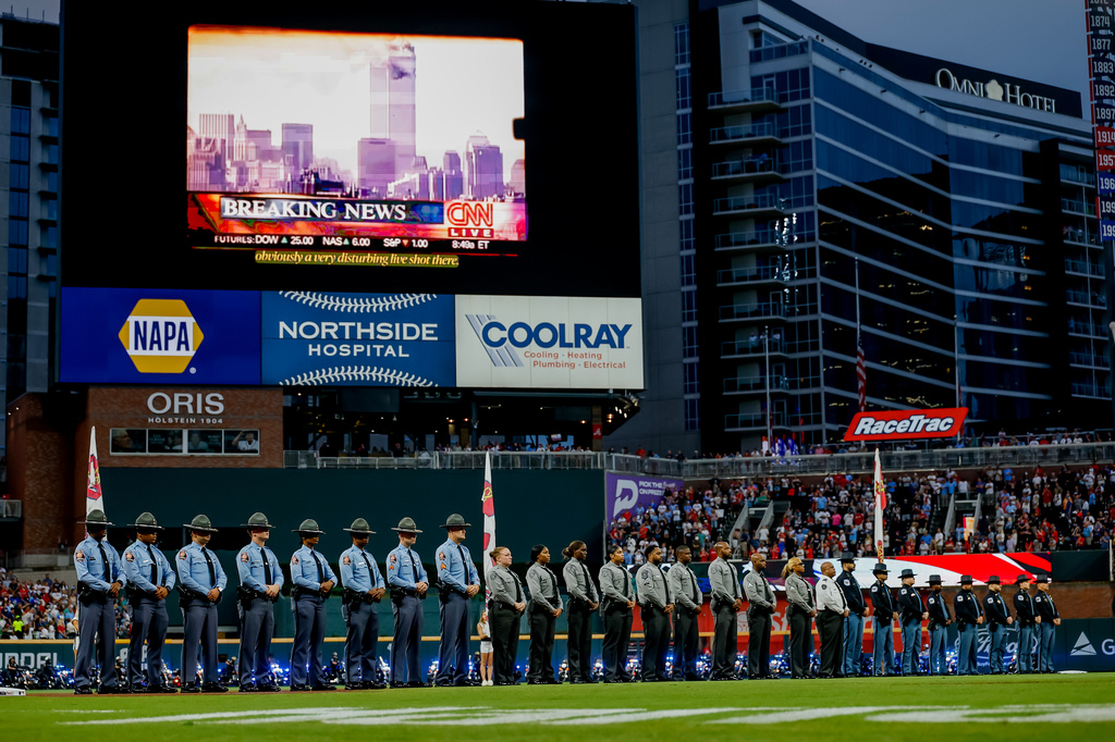 State and local law enforcement officers participate in a 25th anniversary ceremony for the Sept. 11, 2001 terrorist attack on the United States before a baseball game between the Atlanta Braves and the Philadelphia Phillies, Friday, Sept. 11, 2026, in Atlanta. (AP Photo/Erik S. Lesser)