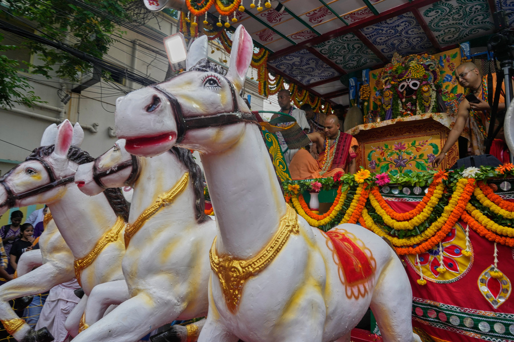 Hindu priests gesture beside the deity of Jagannath during the Rath Yatra, or chariot festival, carrying the Hindu deities of Jagannath, Balaram and Subhadra, in Kolkata, India, Thursday, July 16, 2026. (AP Photo/Bikas Das)
