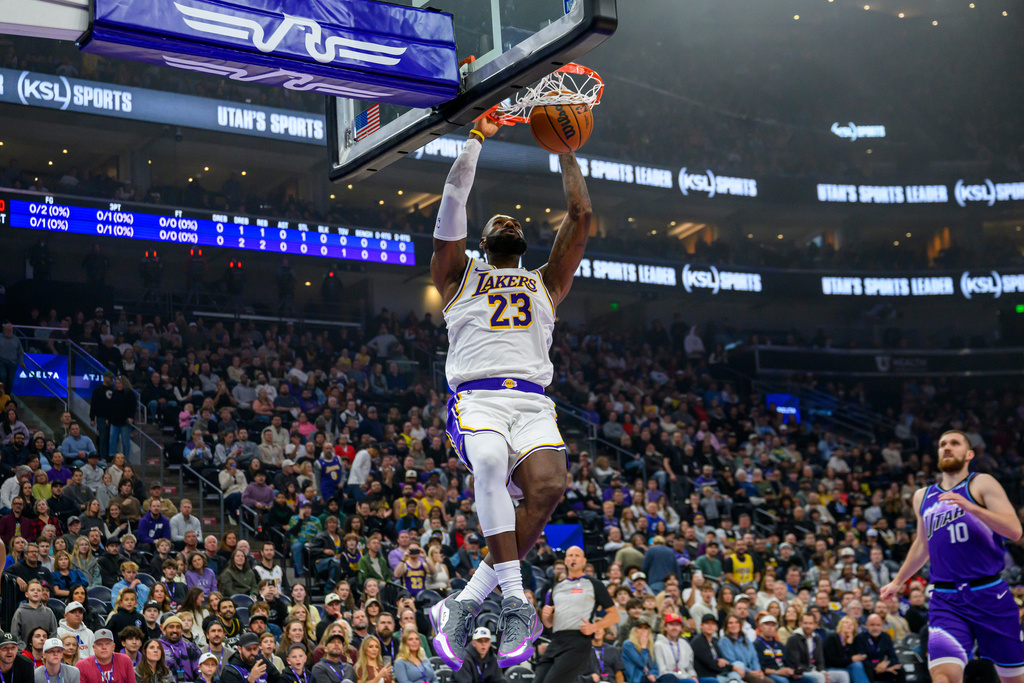 Los Angeles Lakers forward LeBron James dunks the ball during the first half of an NBA basketball game against the Utah Jazz, Sunday, Nov. 23, 2025, in Salt Lake City. (AP Photo/Tyler Tate)