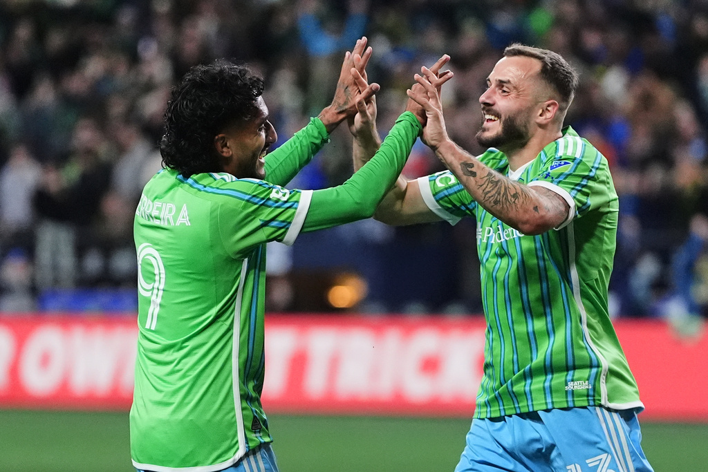 Seattle Sounders forward Jordan Morris, right, celebrates his goal with forward Jesús Ferreira, left, during the first half of Game 2 in the first round of MLS soccer's Western Conference playoffs against Minnesota United, Monday, Nov. 3, 2025, in Seattle. (AP Photo/Lindsey Wasson)
