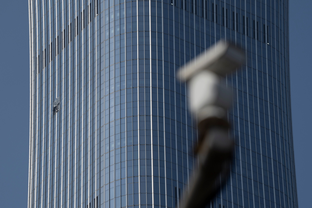 A security camera is seen near a section damaged after a small plane crashed into the CITIC Tower, also known as China Zun, the tallest building in Beijing, on Saturday, June 27, 2026. (AP Photo/Ng Han Guan)
