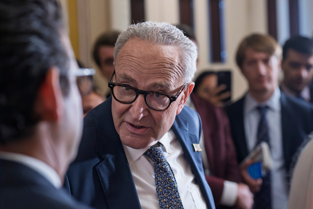 Senate Minority Leader Chuck Schumer, D-N.Y., turns to Sen. Brian Schatz, D-Hawaii, while speaking with reporters as the government lurches toward a shutdown if the Senate does not pass a House measure that would extend federal funding for seven weeks, at the Capitol in Washington, Tuesday, Sept. 30, 2025. (AP Photo/J. Scott Applewhite)