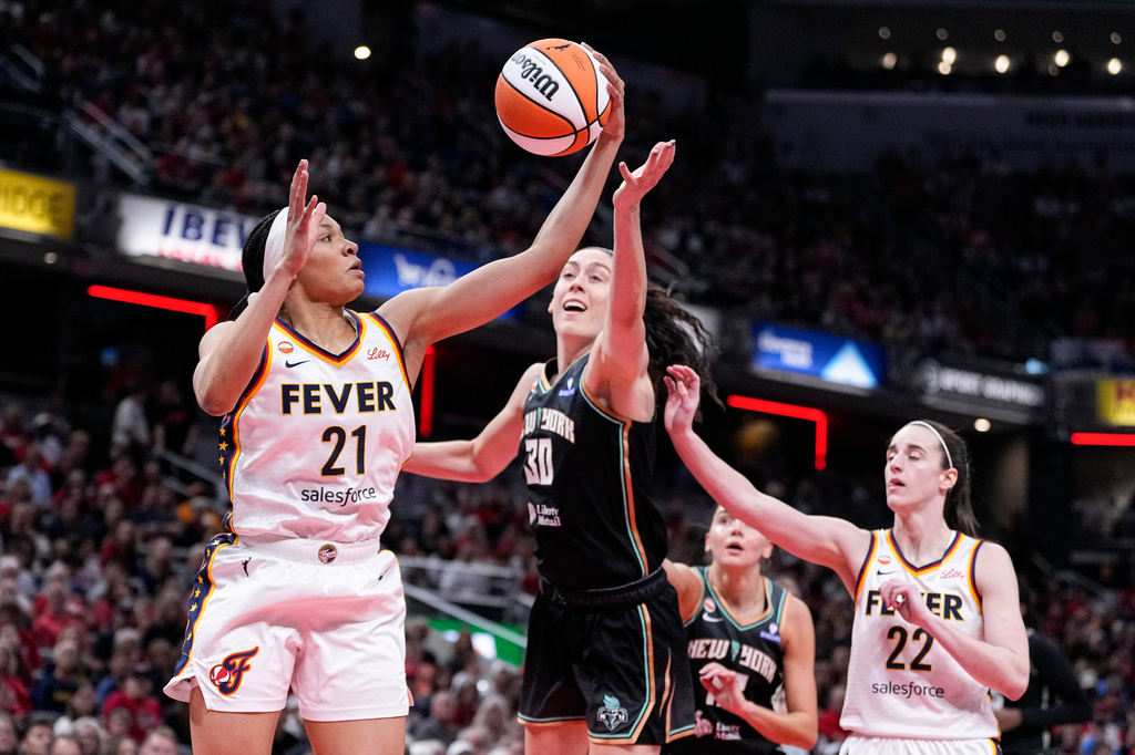 Indiana Fever forward Makayla Timpson (21) grabs a rebound in front of New York Liberty forward Breanna Stewart (30) in the first half of a WNBA basketball game in Indianapolis, Tuesday, Aug. 11, 2026. (AP Photo/Michael Conroy)