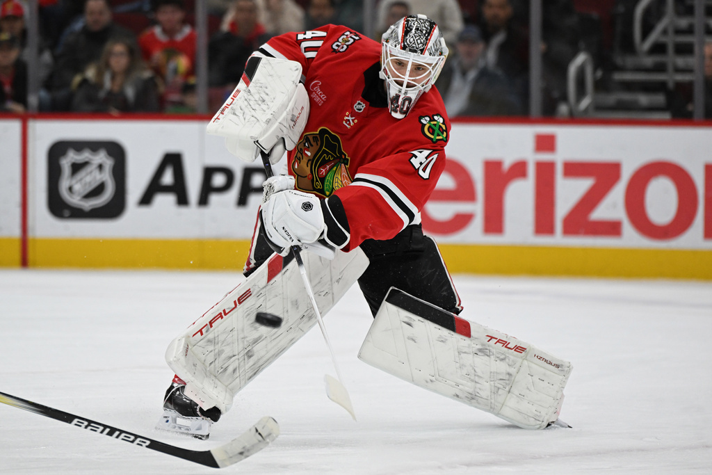 Chicago Blackhawks goalie Arvid Soderblom moves the puck away from the net during the first period of an NHL hockey game against the Vegas Golden Knights, Sunday, Jan. 4, 2026, in Chicago. (AP Photo/Paul Beaty)