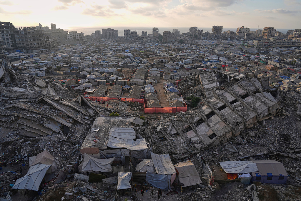 FILE — A tent camp for displaced Palestinians stretches among the ruins of buildings destroyed by Israeli bombardments in west Gaza City, Saturday, June 21, 2025. (AP Photo/Jehad Alshrafi, File)