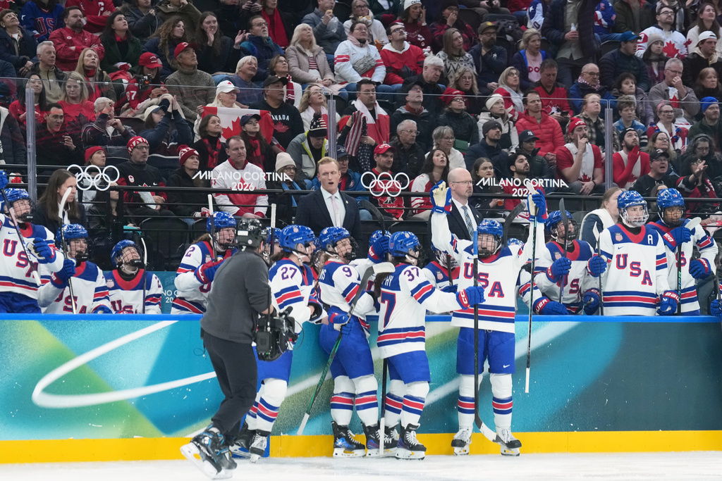 United States players celebrate a goal by Kirsten Simms (9) during second period against Canaday in a preliminary round match of women's ice hockey between USA and Canada at the 2026 Winter Olympics in Milan, Italy, Tuesday, Feb. 10, 2026. (Nathan Denette/The Canadian Press via AP)