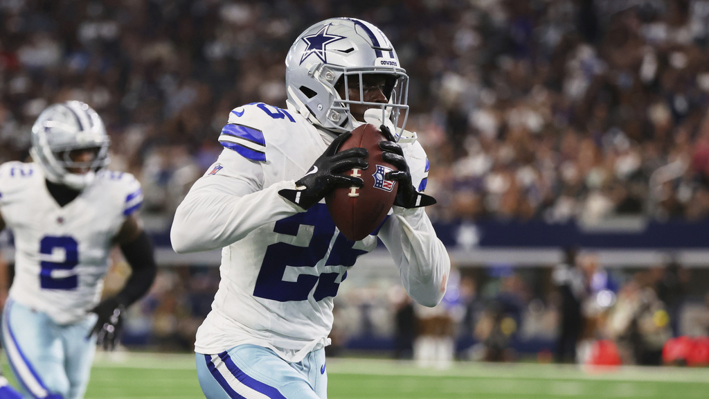 Dallas Cowboys cornerback Andrew Booth intercepts a Baltimore Ravens pass and returns it for a touchdown in the half of a preseason NFL football game Saturday, Aug. 16, 2025, in Arlington, Texas. (AP Photo/Richard Rodriguez)
