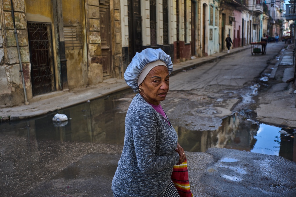 A woman walks through Havana, Cuba, Monday, Feb. 2, 2026. (AP Photo/Ramon Espinosa)