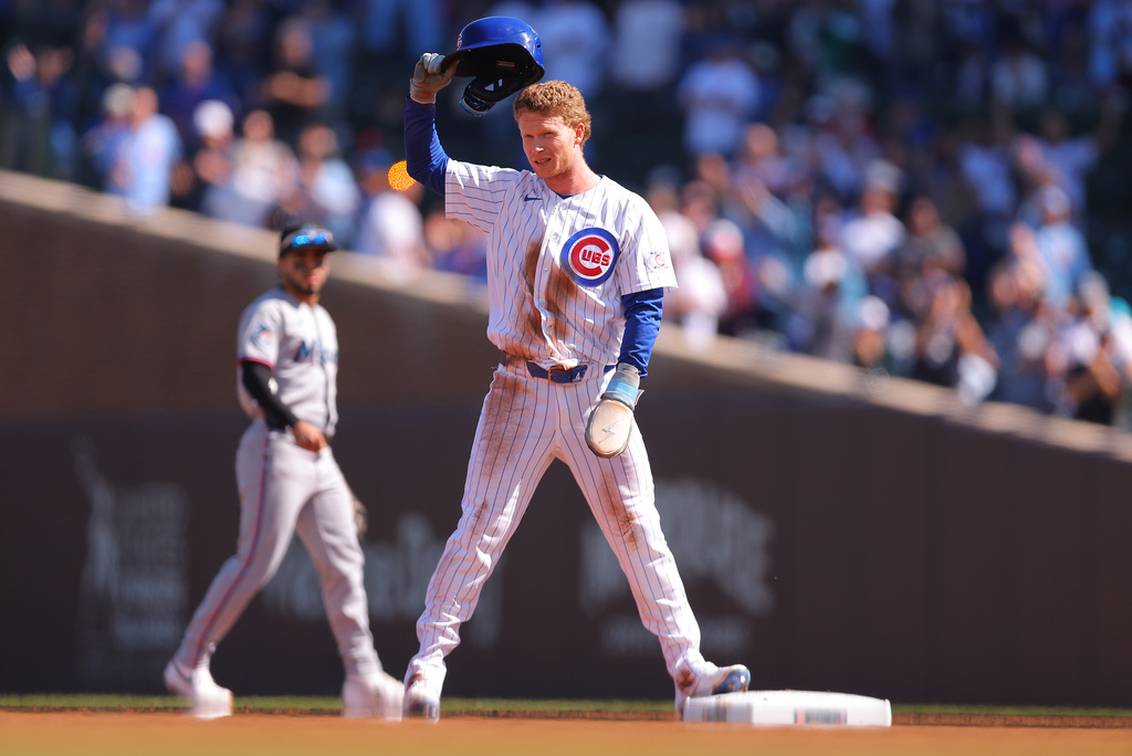 Chicago Cubs' Pete Crow-Armstrong raises his helmet to the crowd after stealing second base for his 40th steal of the season during the first inning of a baseball game against the Miami Marlins, Thursday , Sept. 24, 2026, in Chicago. (AP Photo/Melissa Tamez)
