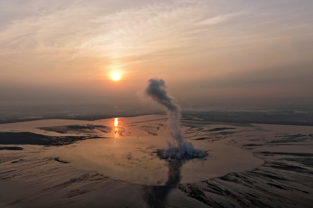 Smoke billows from the crater of the "mud volcano" that was caused by a gas exploration accident in 2006, in Sidoarjo, East Java, Indonesia, Friday, May 29, 2026. (AP Photo/Trisnadi)