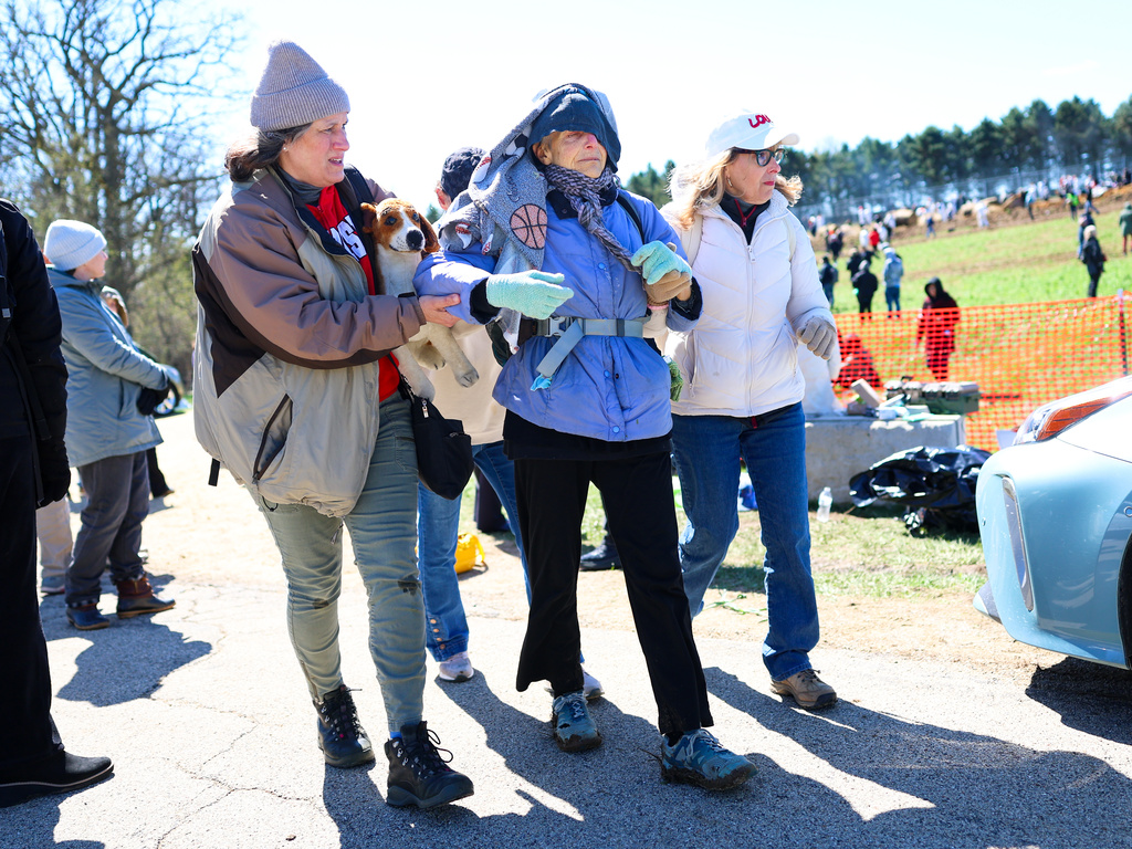 Activists help an elderly woman after she had been tear gassed during an attempt to gain entry into Ridglan Farms beagle breeding and research facility on Saturday, April 18, 2026, in Blue Mounds, Wis. (Owen Ziliak/Wisconsin State Journal via AP)