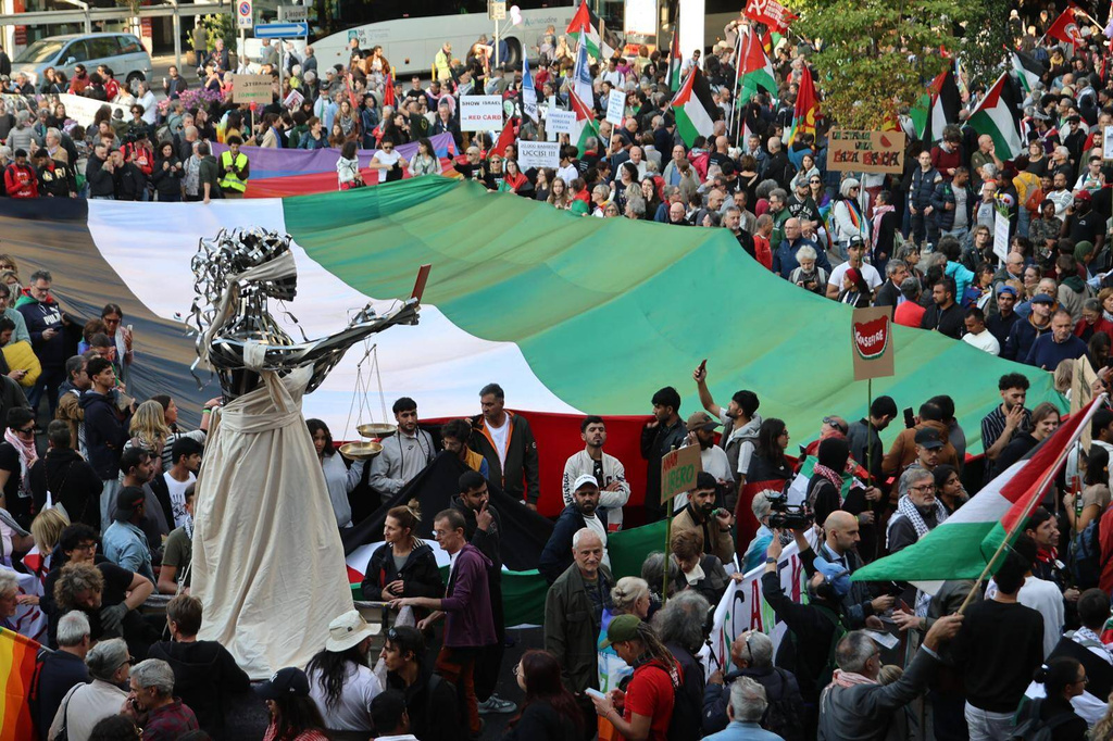 People take part in a pro-Palestinians protest ahead of the 2026 World Cup soccer match between Italy and Israel, in Udine, Italy, Tuesday, Oct. 14, 2025. (Riccardo Modena/LaPresse via AP)
