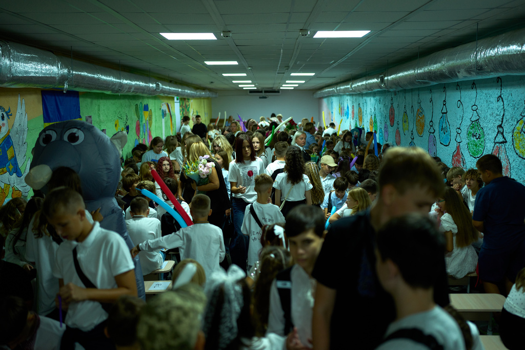 Children, parents and teachers stay in an underground shelter during an air raid alarm during the traditional back to school celebrations in Kyiv, Tuesday, Sept. 1, 2026. (AP Photo/Francisco Seco)