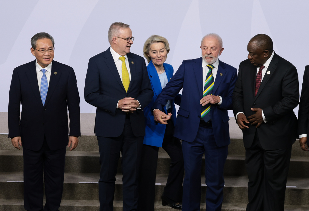 European Commission President Ursula von der Leyen, center, reacts next to Brazil's President Luiz Inacio Lula da Silva, Australia's Prime Minister Anthony Albanese, Chinese Premier Li Qiang, and South Africa's President Cyril Ramaphosa as leaders pose for a group photo, on the opening day of the G20 Leaders' Summit, in Johannesburg, South Africa, Saturday, Nov. 22, 2025. (Yves Herman/Pool Photo via AP)