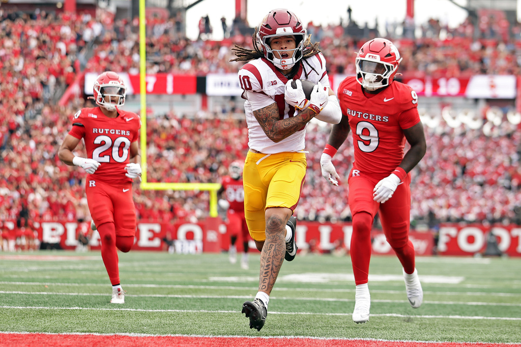 Southern California wide receiver Corey Simms (10) scores a touchdown past Rutgers defensive back Dk Gilley (9) during the first half of an NCAA college football game Saturday, Sept. 19, 2026, in Piscataway, N.J. (AP Photo/Adam Hunger)