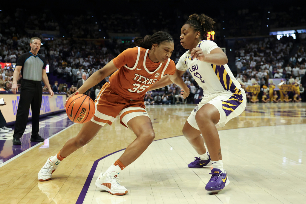 Texas forward Madison Booker (35) tries to drive past LSU guard Mikaylah Williams (12) in the first half of an NCAA college basketball game in Baton Rouge, La., Sunday, Jan. 11, 2026. (AP Photo/Peter Forest)