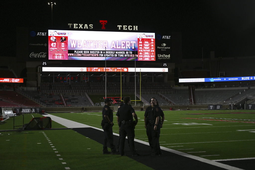 A weather alert is issued for the NCAA college football game between Texas Tech and Arkansas-Pine Bluff, Saturday, Aug. 30, 2025, in Lubbock, Texas. Fans were told to leave the stadium and seek shelter. (AP Photo/Annie Rice)