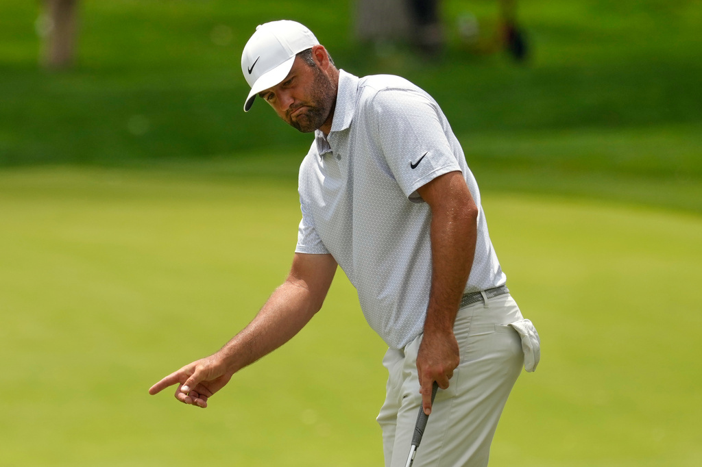 Scottie Scheffler gestures after missing his first putt on the second green in the third round of the Memorial golf tournament, Dublin, Ohio, Saturday, June 6, 2026. (AP Photo/Sue Ogrocki)