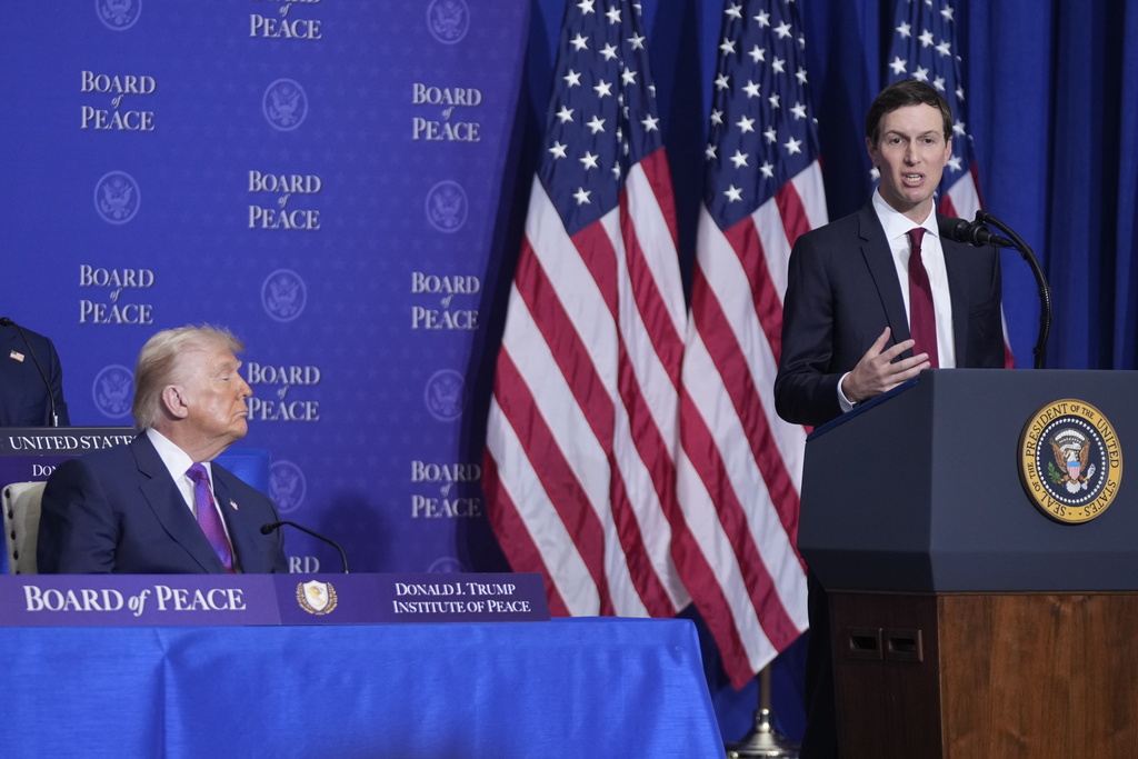 Jared Kushner speaks during a Board of Peace meeting at the U.S. Institute of Peace, Thursday, Feb. 19, 2026, in Washington, as President Donald Trump look on. (AP Photo/Mark Schiefelbein)