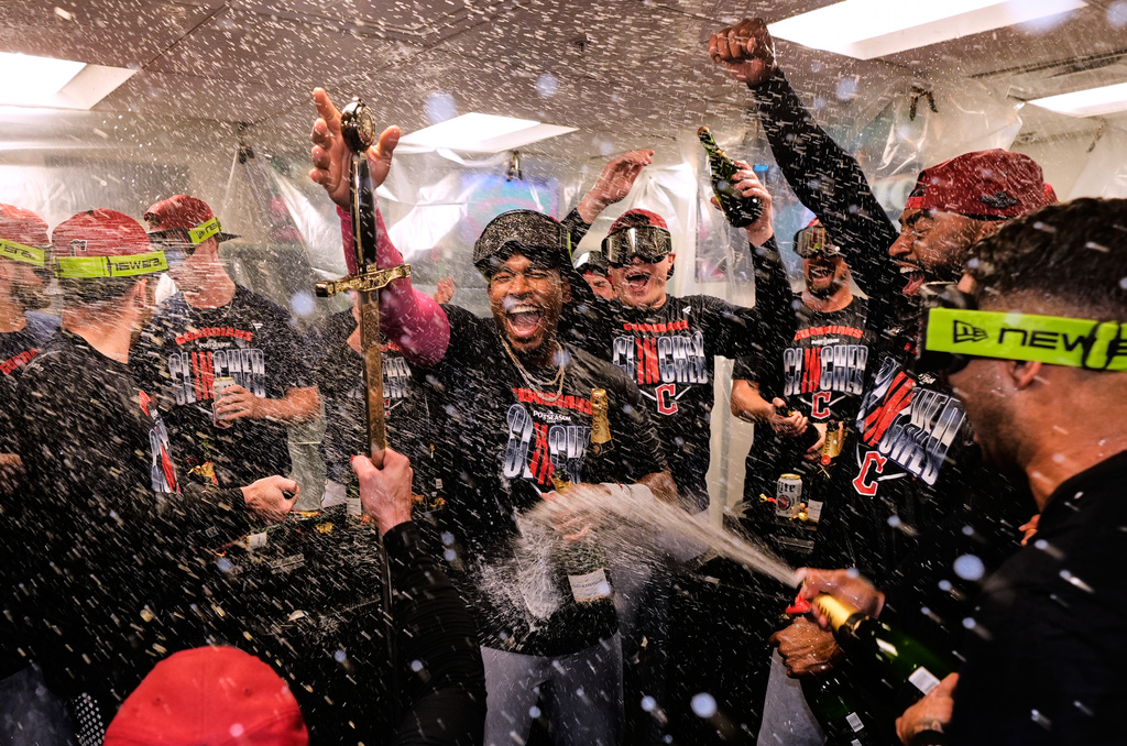 Cleveland Guardians' Angel Mart&iacute;nez, center, celebrates with teammates after clinching a postseason playoff spot following a baseball game against the Boston Red Sox, Thursday, Sept. 24, 2026, in Boston. (AP Photo/Charles Krupa)