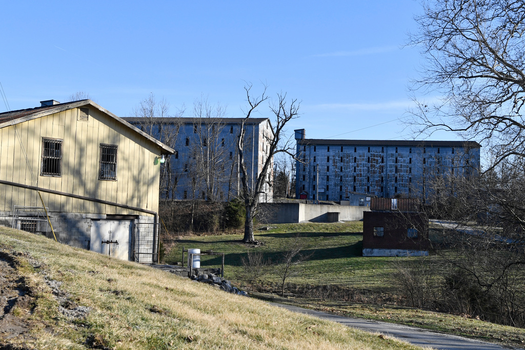 FILE - Bourbon barrel rack houses sit on a hillside at the Four Roses Distillery in Lawrenceburg, Ky., Monday, Feb. 3, 2025. (AP Photo/Timothy D. Easley).