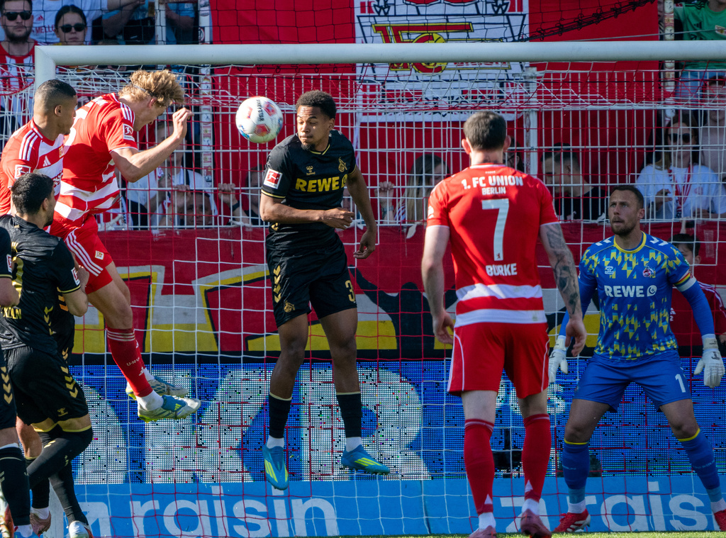 Union Berlin's Tom Rothe, third from left, scores his side's first goal during the German Bundesliga soccer match between 1. FC Union Berlin and 1. FC Köln. (Soeren Stache/dpa via AP)