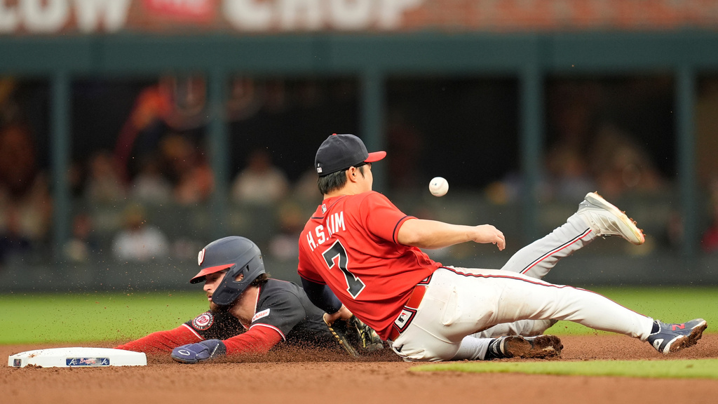 Washington Nationals' Dylan Crews steals second base against Atlanta Braves shortstop Ha-Seong Kim in the third inning of a baseball game, Friday, May 22, 2026, in Atlanta. (AP Photo/Mike Stewart)