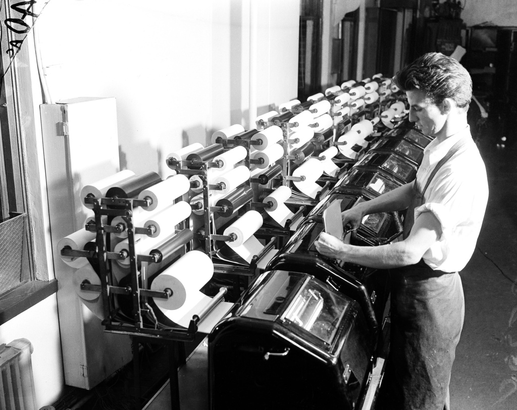 FILE - An Associated Press staffer reads copy from the election tabulator, Nov. 1936. (AP Photo, File)