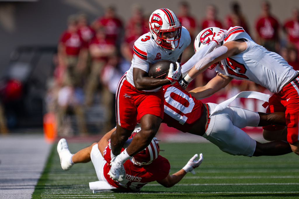 Western Kentucky running back Ajay Allen (3) runs the ball up the sideline during the first half of an NCAA college football game against Indiana, Saturday, Sept. 19, 2026, in Bloomington, Ind. (AP Photo/Doug McSchooler)