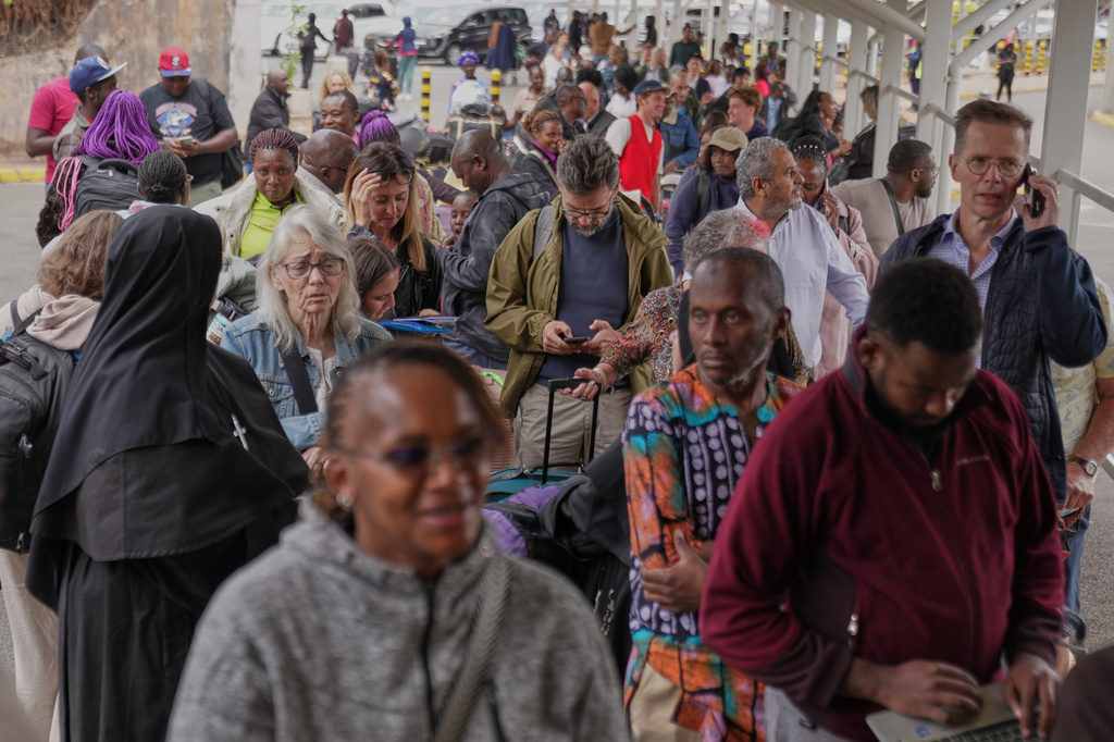 Passengers queue at the departure area during a workers strike at Jomo Kenyatta International Airport in Nairobi, Kenya, Monday, Aug. 31, 2026. (AP Photo/Brian Inganga)