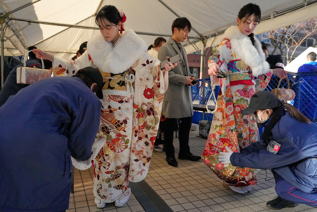 Kimono-clad women are checked at a security checkpoint as they arrive to celebrate the Coming-of-Age Day, a centuries-old tradition and national holiday marking the milestone from childhood to adulthood, Monday, Jan. 12, 2026, in Yokohama near Tokyo. (AP Photo/Eugene Hoshiko)