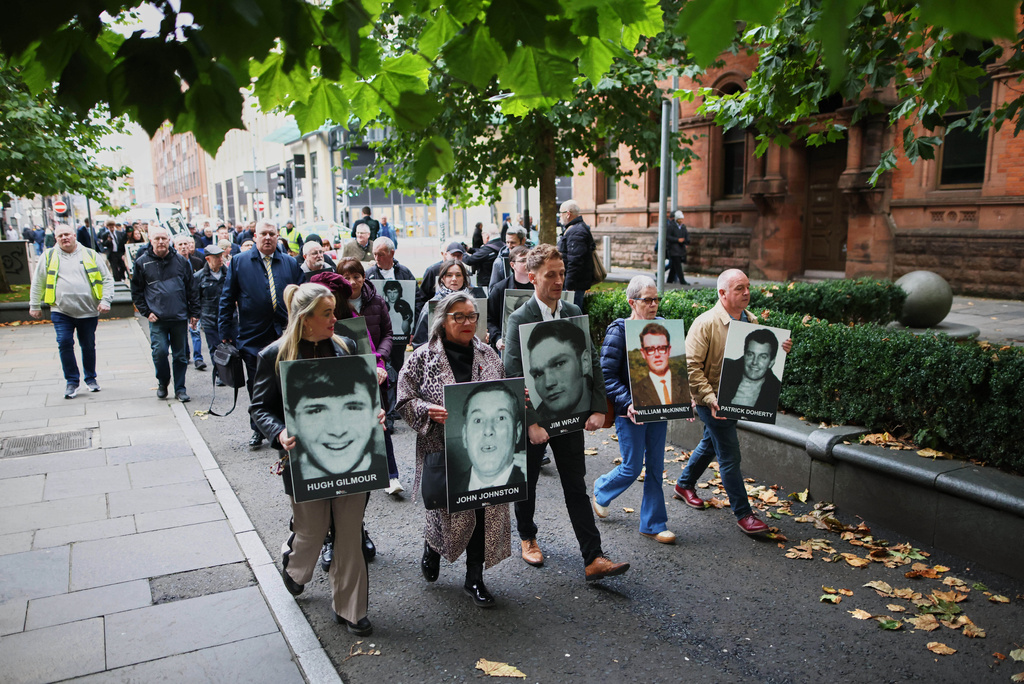 Relatives and supporters of the victims of the 1972 Bloody Sunday massacre march to Belfast Crown Court ahead of the verdict on the trial of a British soldier identified only as Soldier F, Belfast, in Northern Ireland, Thursday, Oct. 23, 2025. (AP Photo/Peter Morrison)