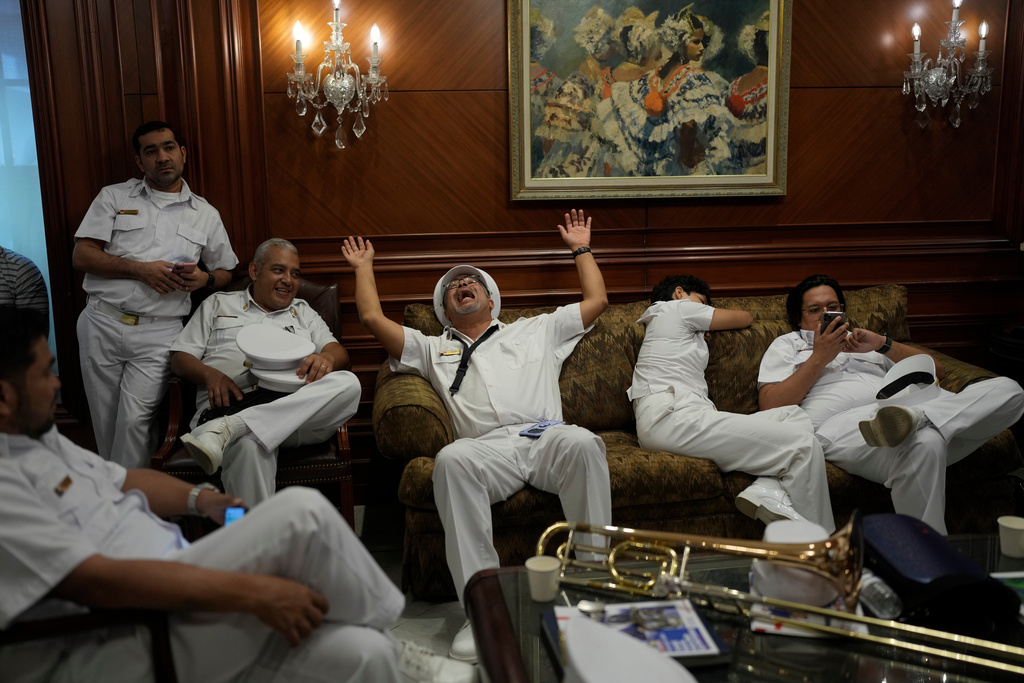 Presidential marching band members wait at the presidential palace to play their instruments during the welcoming ceremony for Brazil's President Luiz Inacio Lula da Silva in Panama City, Wednesday, Jan. 28, 2026. (AP Photo/Matias Delacroix)