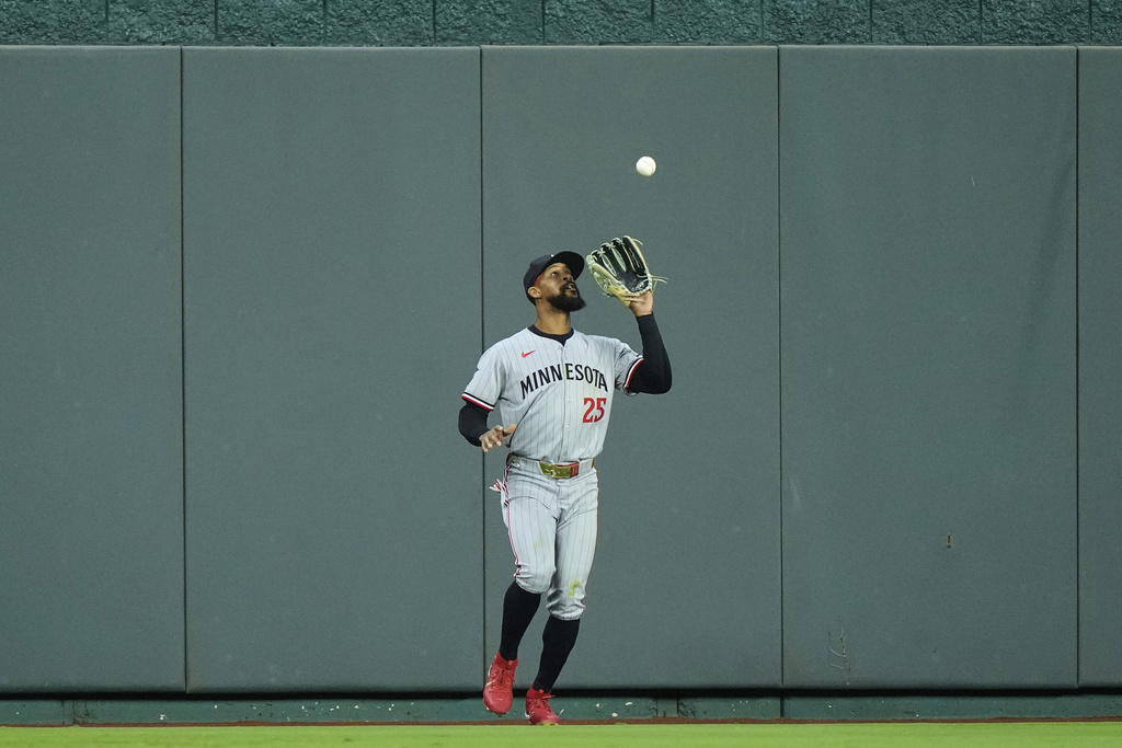 Minnesota Twins center fielder Byron Buxton catches a fly ball for the out on Kansas City Royals' Mike Yastrzemski during the third inning of a baseball game Friday, Sept. 5, 2025, in Kansas City, Mo. (AP Photo/Charlie Riedel)