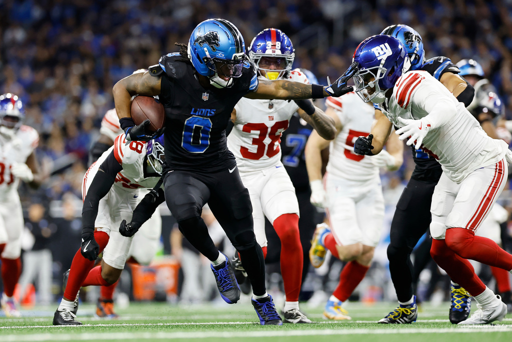 Detroit Lions running back Jahmyr Gibbs (0) runs against the New York Giants during the second half of an NFL football game in Detroit, Sunday, Nov. 23, 2025. (AP Photo/Rey Del Rio)