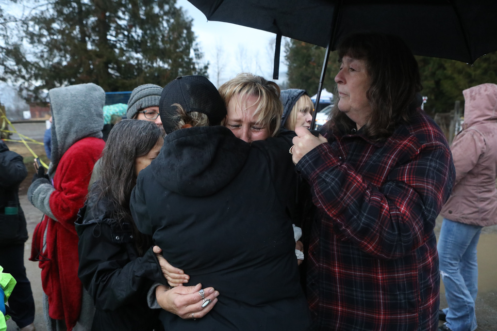 Karen Espersen, the co-owner of Universal Ostrich Farms, embraces her daughter, Katie Pasitney, at the farm in Edgewood, B.C., following the announcement that the Supreme Court of Canada dismissed the farm's appeal to stay an order to cull more than 300 of its ostriches on Thursday, Nov. 6, 2025. (Aaron Hemens /The Canadian Press via AP)