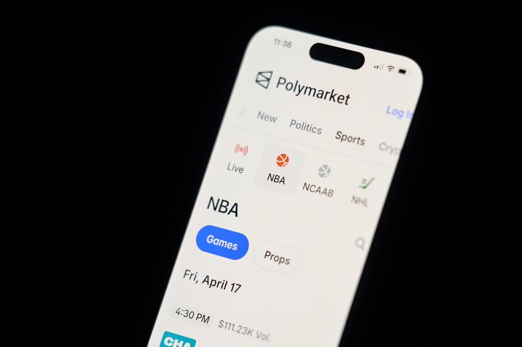 A phone displays sports trades on Polymarket on Thursday, April 16, 2026, in Portland, Ore. (AP Photo/Jenny Kane)