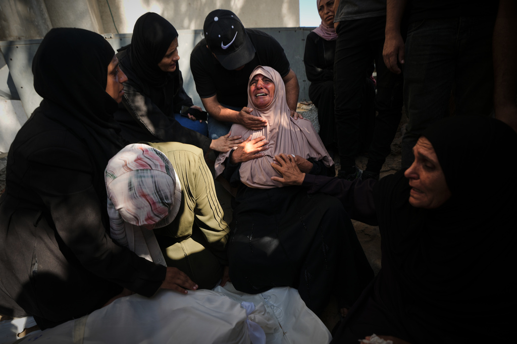 Mourners attend the funeral of Palestinians who were killed in an Israeli army strike on a cafe at the Gaza port the previous day, at Shifa Hospital in Gaza City, Wednesday, Aug. 19, 2026. (AP Photo/Jehad Alshrafi)