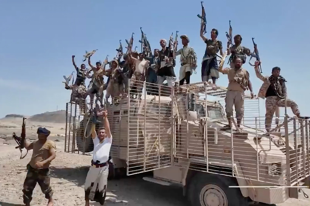 This image taken from undated video released by the Houthi-run Al-Masirah television channel on Saturday, Sept. 12, 2026, shows Houthi fighters chanting and raising rifles atop a military vehicle in Dhubab district, Taiz province, Yemen, according to the channel. (Al-Masirah TV via AP)
