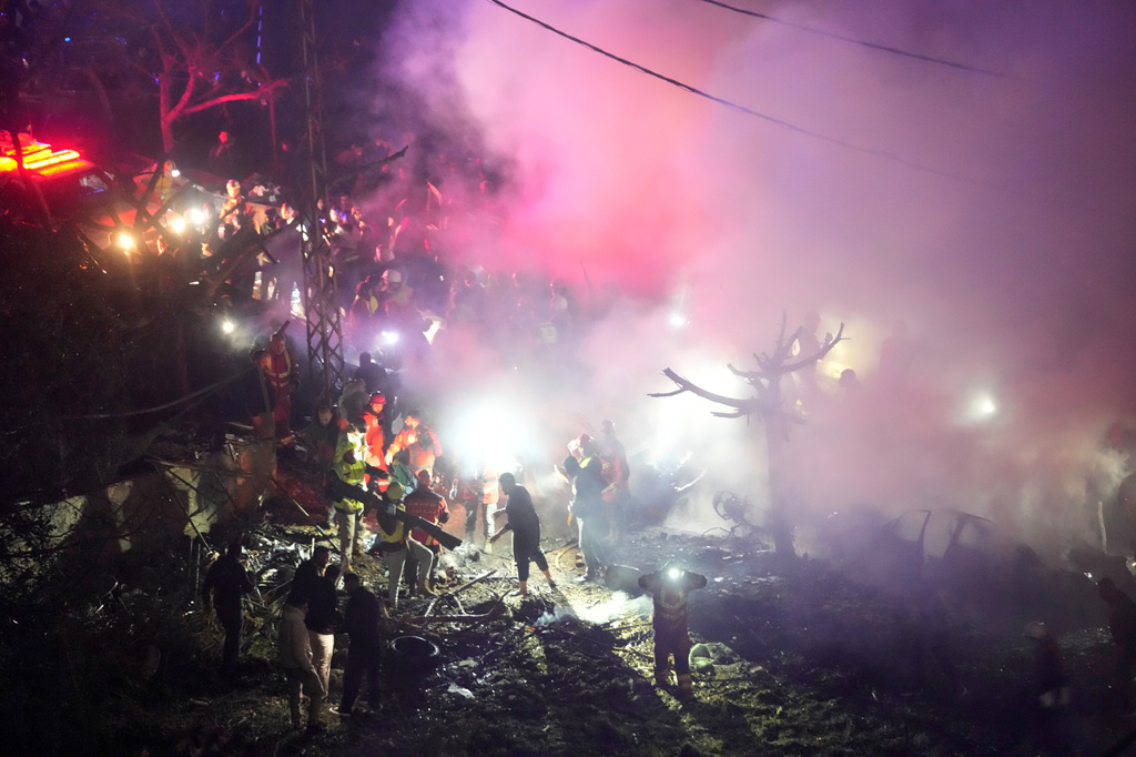 Rescue workers inspect the scene of Israeli airstrikes, in Beirut, Lebanon, Wednesday, April 1, 2026. (AP Photo/Hussein Malla)