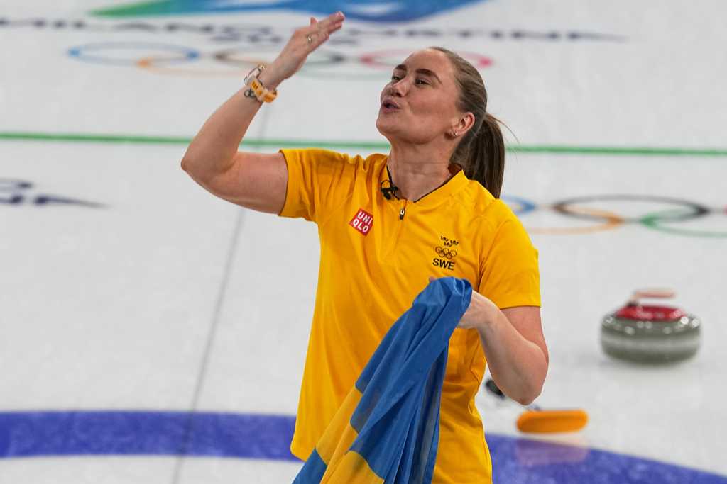 Sweden's Sara McManus celebrates defeating Switzerland to win a women's curling gold medal match, at the 2026 Winter Olympics, in Cortina d'Ampezzo, Italy, Sunday, Feb. 22, 2026. (AP Photo/Fatima Shbair)