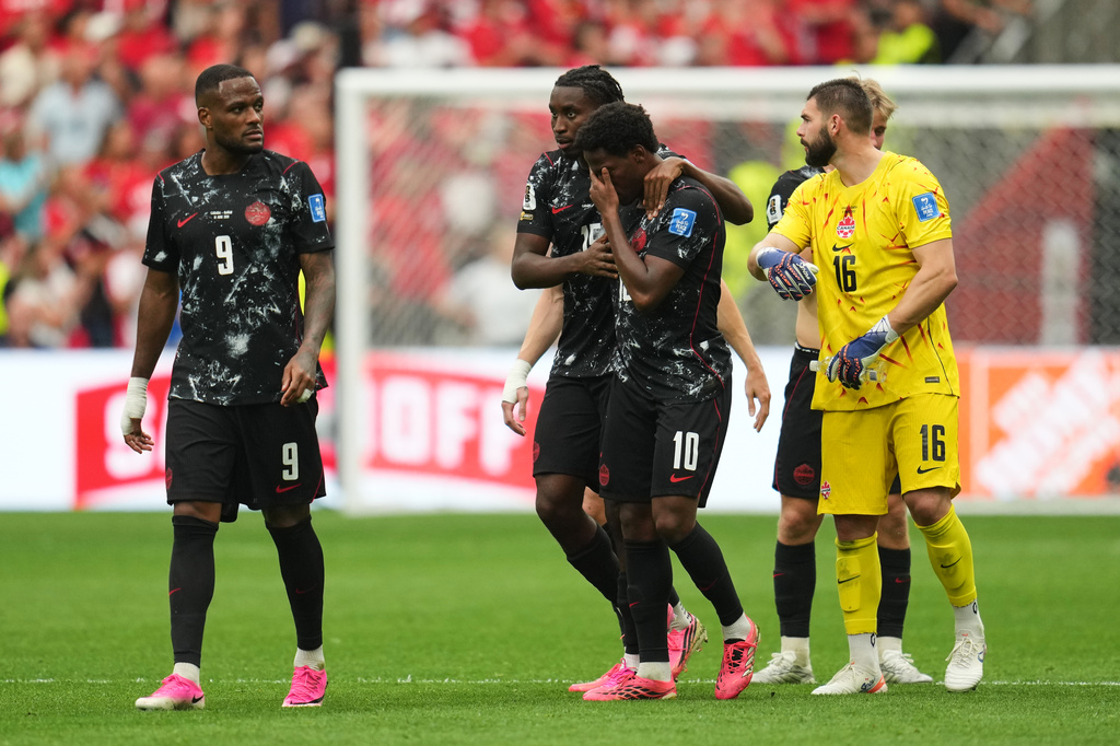 Canada's Jonathan David, third from left, becomes emotional after Ismael Kone sustained an injury and was taken off the field during the World Cup Group B soccer match against Qatar in Vancouver, British Columbia, Thursday, June 18, 2026. (AP Photo/Abbie Parr)