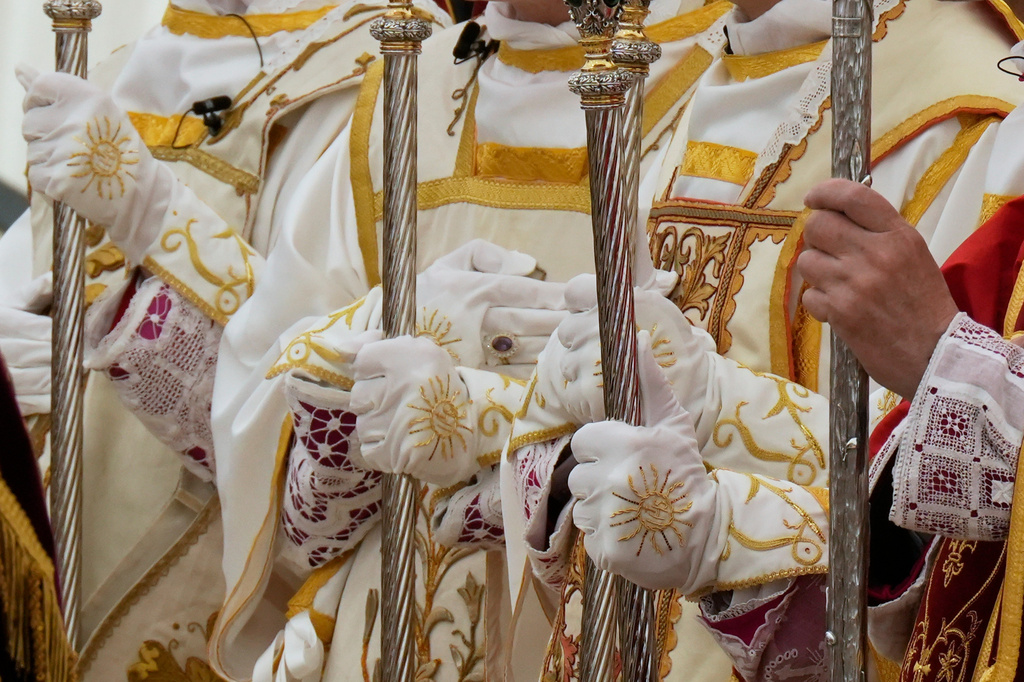 Newly consecrated Bishops, from left, Pascal Schreiber, Michael Goldade, Michel Poinsinet de Sivry and Marc Hanappier hold their pastoral staffs at the end of their consecration ceremony in a tent set up outside the Society of St. Pius X seminary in Econe, Switzerland, Wednesday, July 1, 2026. (AP Photo/Baz Ratner)