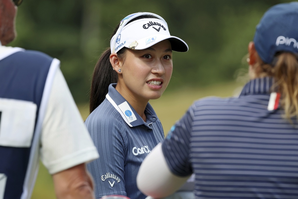 Atthaya Thitikul, of Thailand, talks with Lauren Coughlin while waiting to tee off on the eighth hole during the first round of the FM Championship LPGA golf tournament at TPC Boston, Thursday, Aug. 28, 2025, in Norton, Mass. (AP Photo/Michael Dwyer)