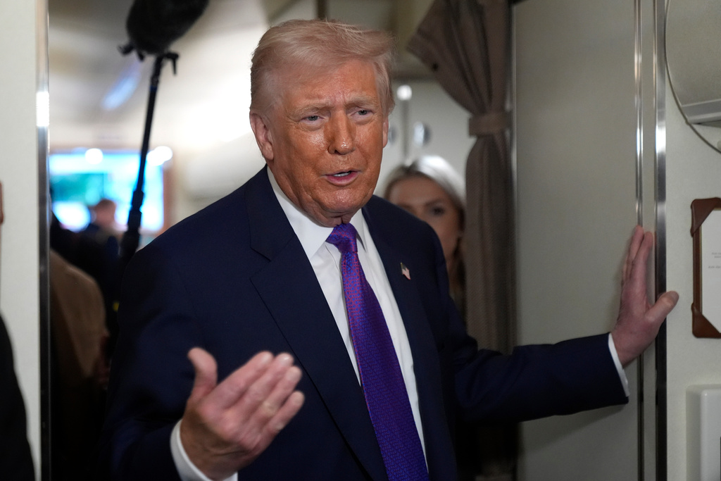President Donald Trump speaks to reporters aboard Air Force One shortly before takeoff, Thursday, Feb. 19, 2026, at Joint Base Andrews, Md. (AP Photo/Mark Schiefelbein)