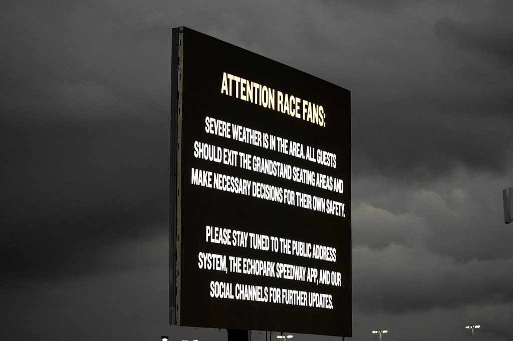 Severe weather moves through as cars stop in pit row during a NASCAR Cup Series auto race, Sunday, July 12, 2026, in Hampton, Ga. (AP Photo/Mike Stewart)
